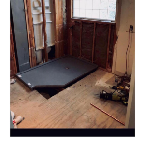 A bathroom renovation in progress with exposed studs and a new shower pan installed by Juan The Handyman LLC in Kansas City, KS