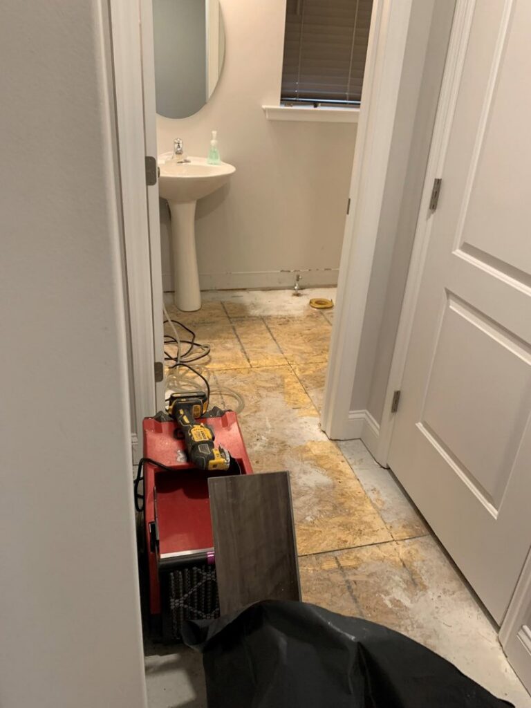 A bathroom renovation in progress with subfloor exposed and construction equipment, managed by Lancaster Home Builders in Lancaster, PA.