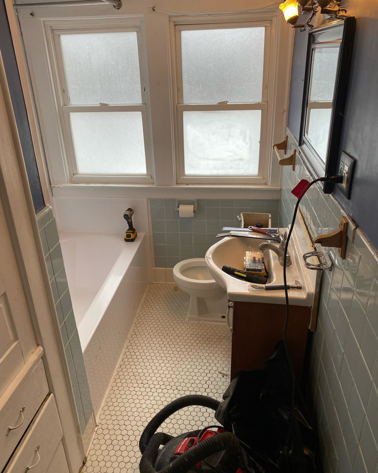 A bathroom undergoing renovation with tools and materials by Mohawk Home Improvement of Syracuse LLC in Syracuse, NY.