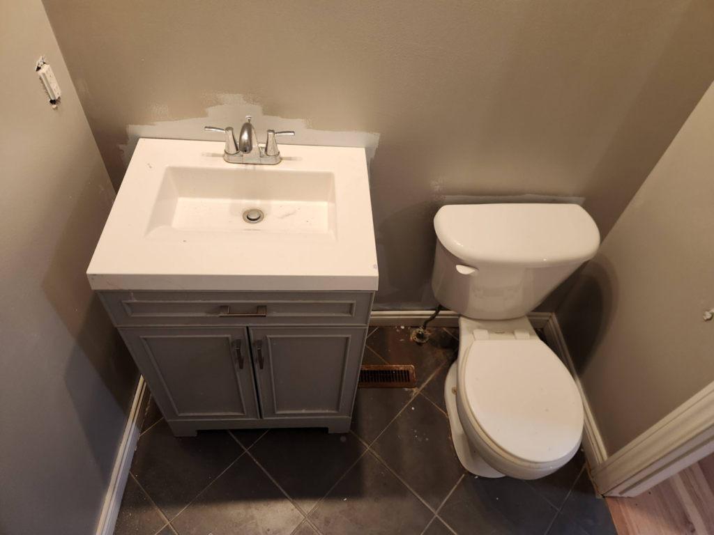 Bathroom renovation in progress with old vanity and toilet, ready for upgrades by SG Service, LLC in Lincoln, NE
