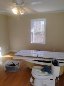 A bathroom renovation in progress with a toilet and doors removed, showcasing handyman services by Supernatural Drywall in Augusta, GA