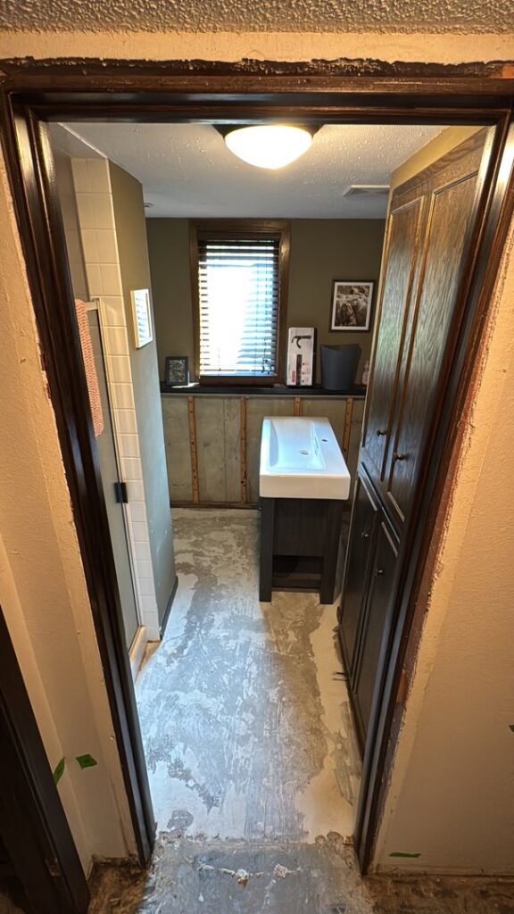 A bathroom renovation in progress with a new vanity and sink installed by Hawk Handyman Services in West Fargo, ND