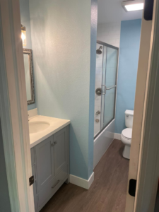 A bright bathroom renovation with a new vanity, fresh paint, and a shower-tub combination by Tanner Custom Carpentry in Loveland, CO.