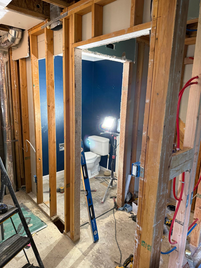 Bathroom renovation with exposed plumbing and framing by Alex Home Pro Colorado, a handyman service in Denver, CO.