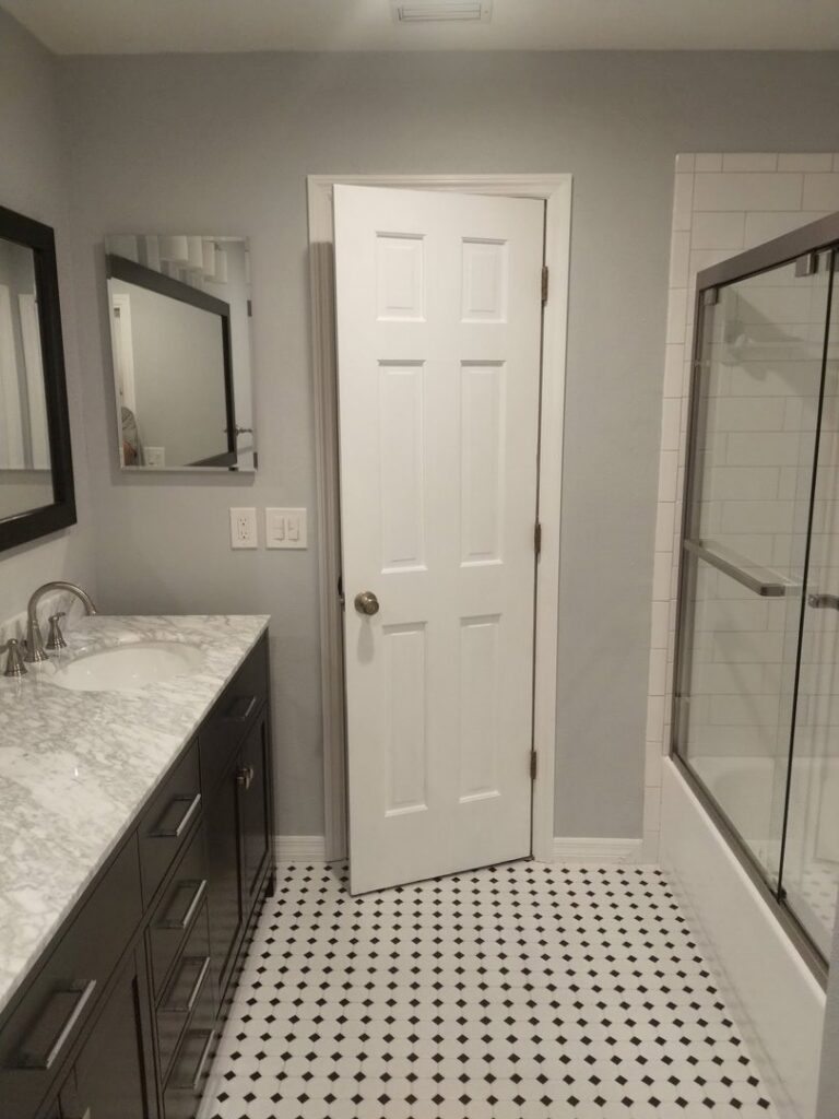 A complete bathroom renovation project featuring new vanity, mirror, and tile work by Serene Construction, LLC in Richmond, VA.