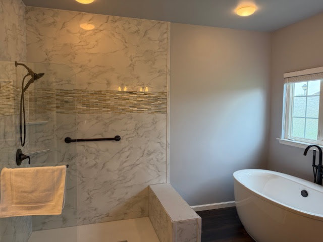 A completed bathroom renovation featuring a modern shower and a freestanding tub by Peninsula Bath & Tile in Salisbury, MD.