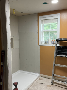 Bathroom renovation in progress with a new shower pan installed and drywall by Jay's Construction in Cincinnati, OH.