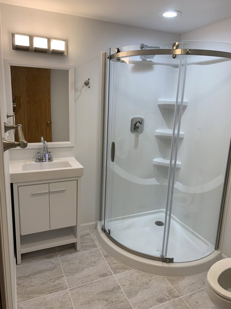 Full bathroom renovation with new shower, vanity, and fixtures by Segovia LLC interiors in Madison, WI.