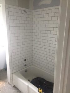 A bathroom renovation with new subway tile installed around a bathtub by Carl Gardner Contracting in Syracuse, NY.