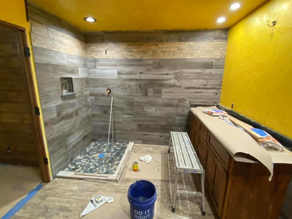 Bathroom renovation with tile installation project in progress by Quality Craftsman Construction in Longwood, FL.