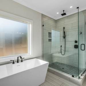 A modern bathroom renovation with a freestanding tub and glass-enclosed walk-in shower by Mitchco, Inc. in Winston-Salem, NC.