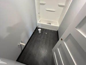 A bathroom renovation project showing a new bathtub, exposed plumbing, and new flooring installed by Drew's Home Repair and Handyman Service in Wichita, KS.