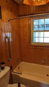 A bathroom undergoing renovation with wood paneling and new fixtures being installed by Devil Dog Services LLC in Billings, MT.