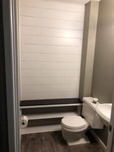 A newly installed shiplap wall and bench in a bathroom by Gwen Co in St. Louis, MO.