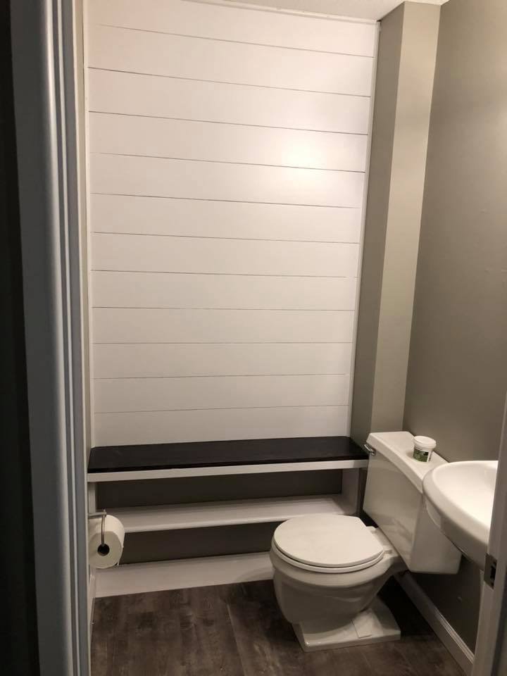 A newly installed shiplap wall and bench in a bathroom by Gwen Co in St. Louis, MO.
