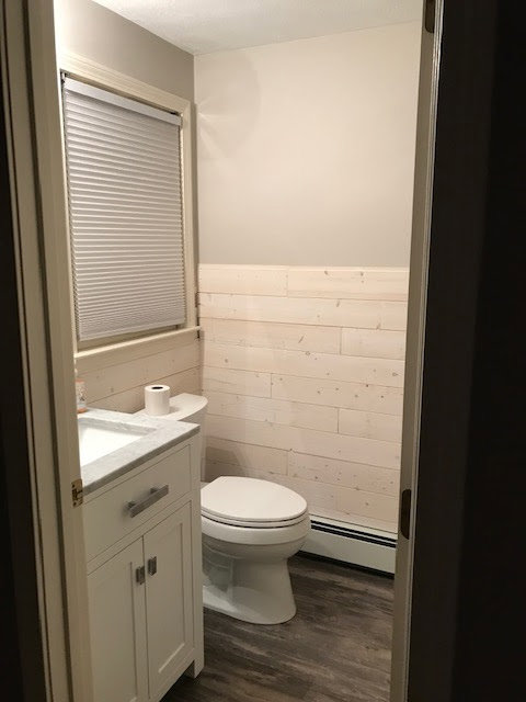 A small bathroom featuring newly installed shiplap-style wall paneling, completed by Sini's Handyman Services in Falmouth, ME.