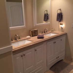 A renovated bathroom featuring a tiled shower with a glass partition and a bathtub, completed by Holland Construction LLC in Tucson, AZ.