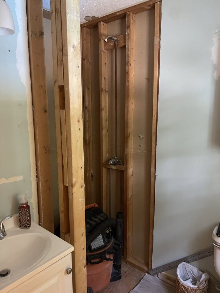 Bathroom renovation in progress, showing shower framing and plumbing rough-in by Granite State Handyman & Home Repair in Derry, NH.