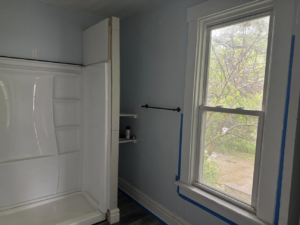 Bathroom renovation with new shower installation and window trim taped for painting by JW Contracting Services, LLC in Dayton, OH.