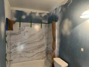 Bathroom renovation in progress with new shower panel installation by High Plains Craftsmen in Cheyenne, WY.