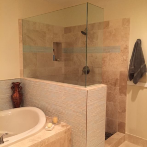 A bathroom shower remodel in progress, showing partial tile installation by Holland Construction LLC in Tucson, AZ.