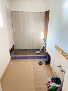Bathroom shower renovation in progress, showing shower pan and wall backer board installation by Guzmanremodeling LlC in Renton, WA.