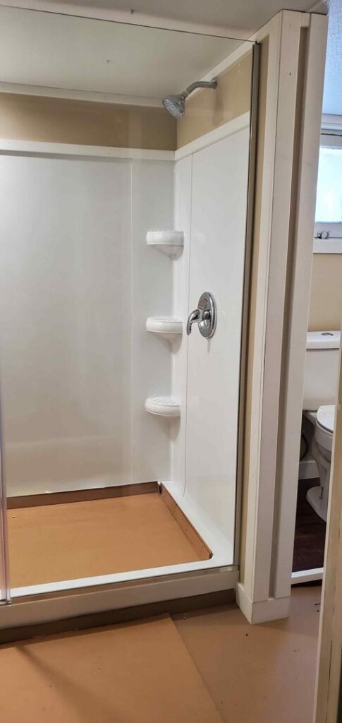 A newly installed shower stall with modern fixtures by Constructed by 360 LLC in Meridian, ID.