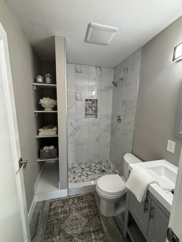 A beautifully remodeled bathroom featuring new shower tile installation and vanity by A to Z Remodeling llc in Gresham, OR.