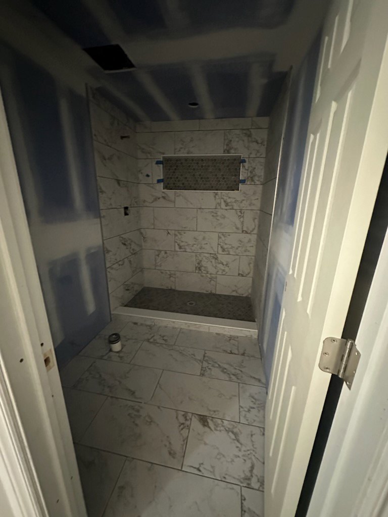Bathroom shower under construction with new tile installation by Universal Builders LLC in New Haven, CT.