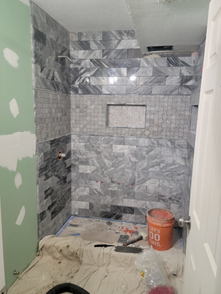 Bathroom shower tiling and renovation work in progress by Smith Finishes LLC in Everett, WA.