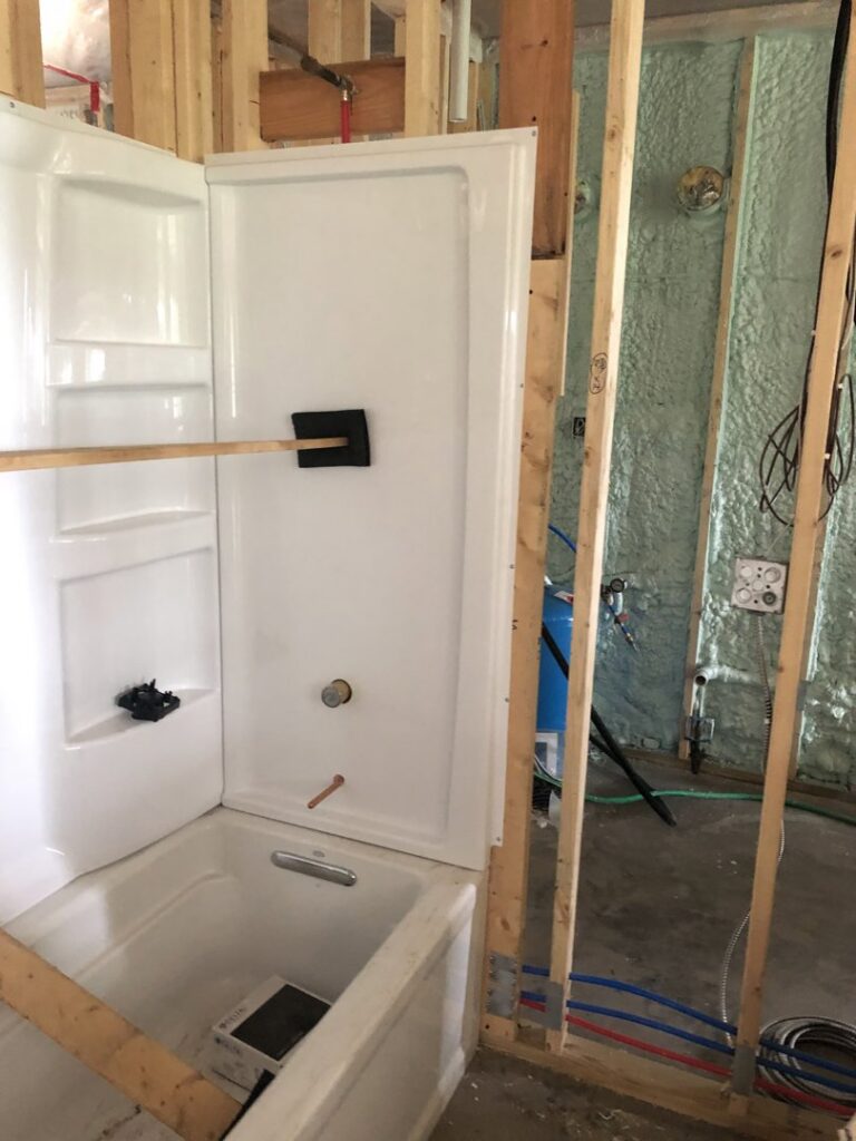 Bathroom shower and tub unit installation during new construction by Northern Air Plumbing & Heating in Aitkin, MN