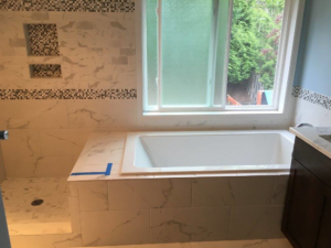 Bathroom tile installation around a bathtub and shower area by Bailey Contracting, LLC in Lake Oswego, OR.