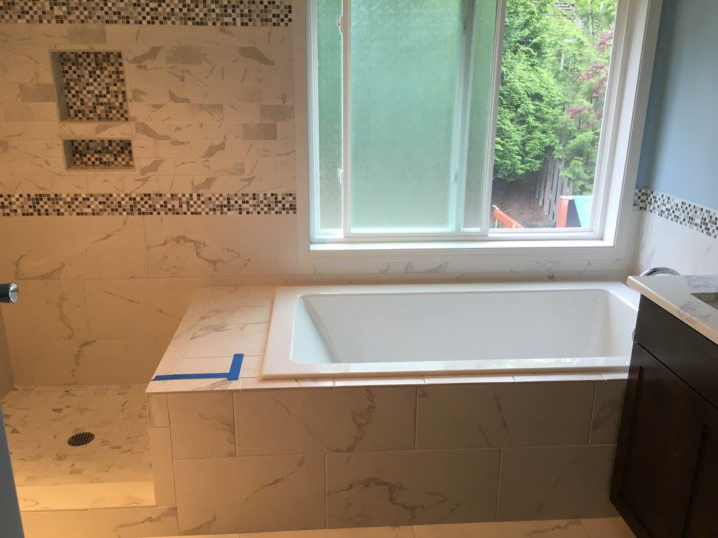 Bathroom tile installation around a bathtub and shower area by Bailey Contracting, LLC in Lake Oswego, OR.
