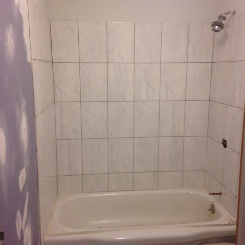 Bathroom renovation in progress showing new tile installation around a bathtub by Amazing Handyman in Peoria, IL.