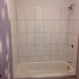 Bathroom renovation in progress showing new tile installation around a bathtub by Amazing Handyman in Peoria, IL.
