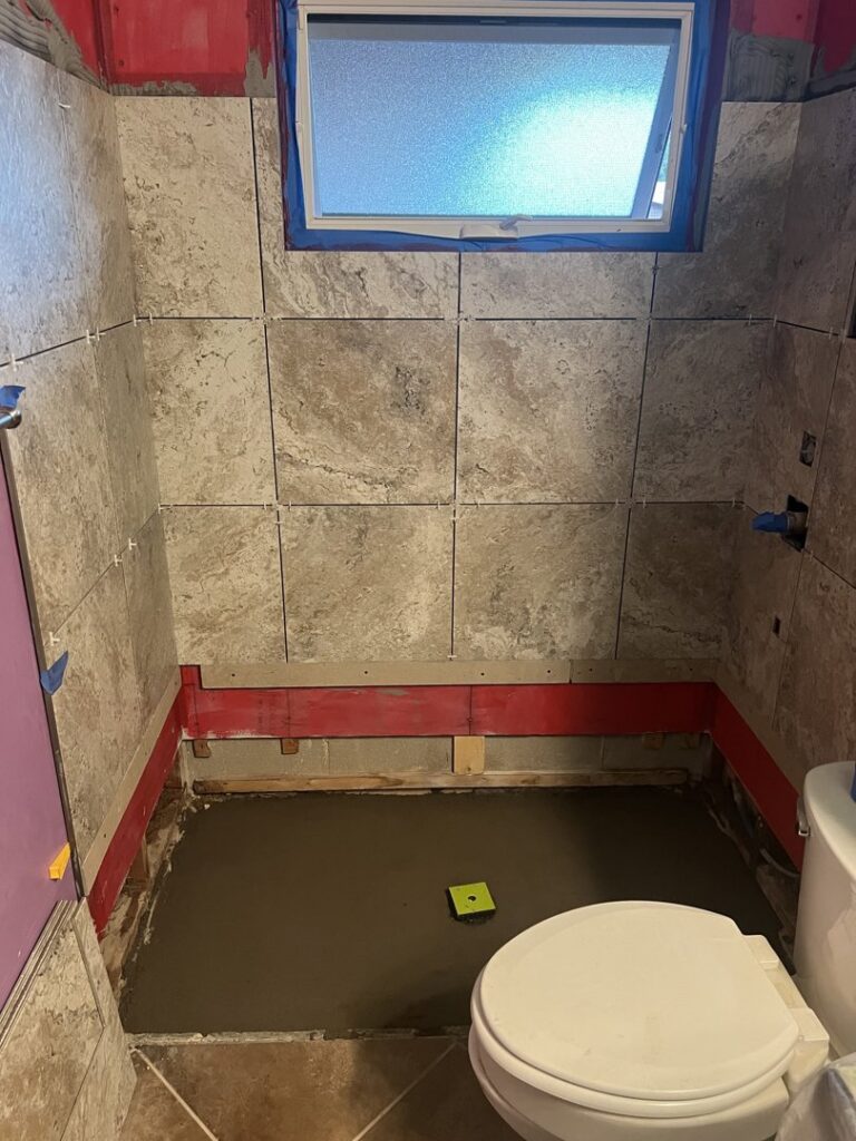 A completed bathroom featuring a bathtub and newly tiled walls, a service provided by Holland Construction LLC in Tucson, AZ.