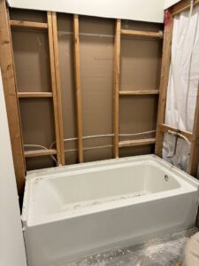 A bathroom tub installation in progress with exposed wall studs by Peninsula Bath & Tile in Salisbury, MD.