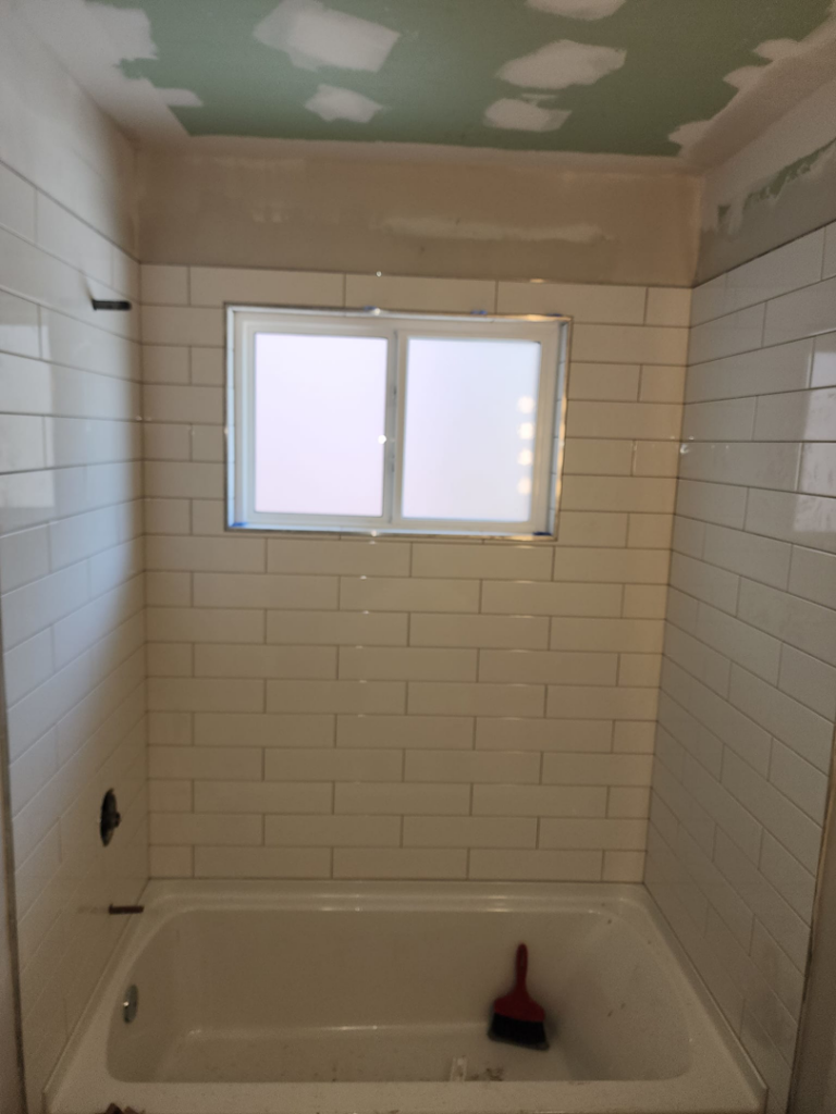A new bathtub and subway tile walls installed during a bathroom remodel by Excalibur Home Services in Council Bluffs, IA.