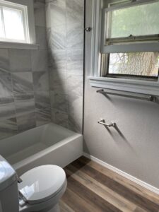 A renovated bathroom with new tub tile and flooring completed by HandyMation in Cheyenne, WY