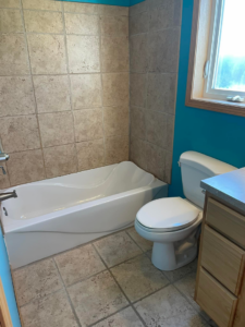 A newly installed bathtub and toilet in a bathroom by Capital T's Home Specialty LLC in Topeka, KS.