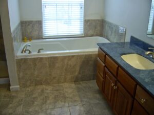 A bathroom with a built-in tub and vanity installed by Indy Renovation in Indianapolis, IN.