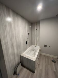 Bathroom remodel in progress with new tub and wall panel installation by Handyman house repairs and remodeling in Provo, UT