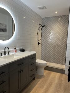 Bathroom vanity and illuminated mirror installation by Jocia Construction Services in Gilbert, AZ.