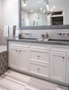A newly installed custom bathroom vanity with white cabinets and double sinks by ArcherRead Woodworking in Wilmington, NC