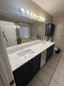 A newly installed white quartz countertop and sinks on a bathroom vanity by Victor's Granite Counter-Tops in Millcreek, UT.