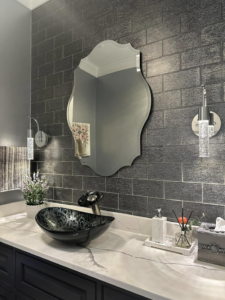 A bathroom vanity area with dark brick-patterned wall tiles and a vessel sink by A&L Tile LLC in San Diego, CA
