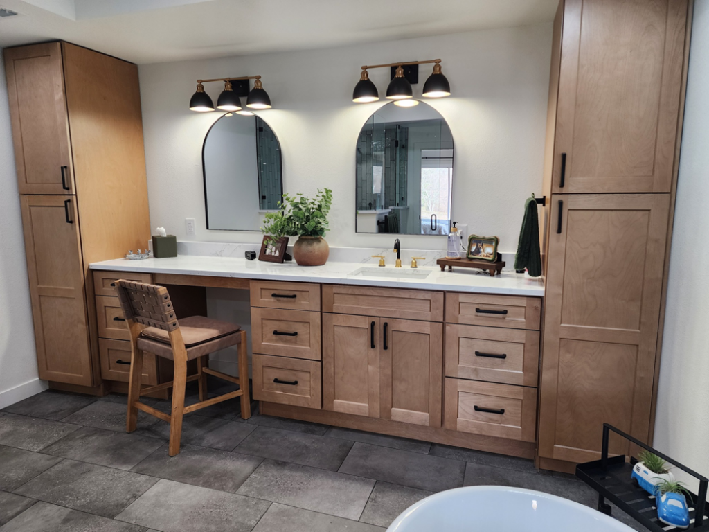 A spacious bathroom vanity with double sinks, arched mirrors, and custom cabinets by Slater Cabinets and More in Springfield, MO.