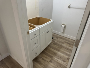 A new bathroom vanity cabinet installed in a small bathroom during a home renovation by Bradford Brothers Builders Inc. in Cape Coral, FL