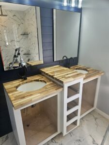 A bathroom vanity installation in progress with dual sinks and butcher block countertops by KB Home Repairs & Improvements, LLC in Shawnee, KS.