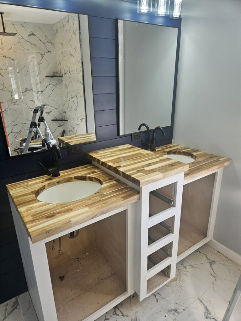 A bathroom vanity installation in progress with dual sinks and butcher block countertops by KB Home Repairs & Improvements, LLC in Shawnee, KS.